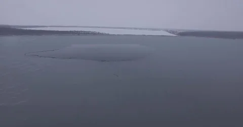 The frozen surface of the lake, cold winter Stock Footage 83564929