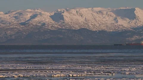 Frozen Tidal Mud Flats Pan to Tanker and Mountains Stock Footage 8961334