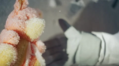 Frozen toy analysis performed by scientist in icy laboratory setting Stock Footage 346474544