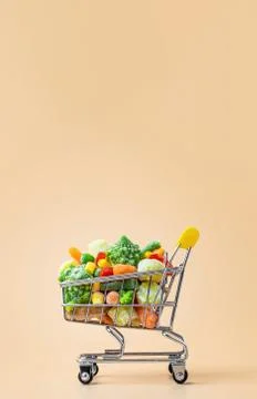 Frozen vegetables assorted on beige, vertical Stock Photos