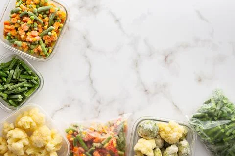 Frozen vegetables in containers Stock Photos