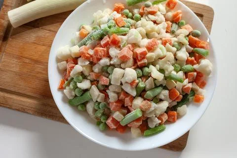 Frozen vegetables cut into cubes on a plate Stockfoto's