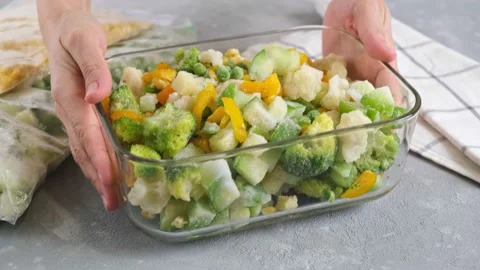 Frozen vegetables in a glass container. Mix of frozen vegetables. Frozen food. Stock Footage 151162308