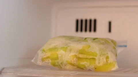 Frozen vegetables in plastic bags in freezer close-up, front view Stock Footage 146841579