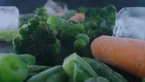 Frozen vegetables on table,cauliflower,carrots,peas,string beans,Concept of Stock Footage 130996658