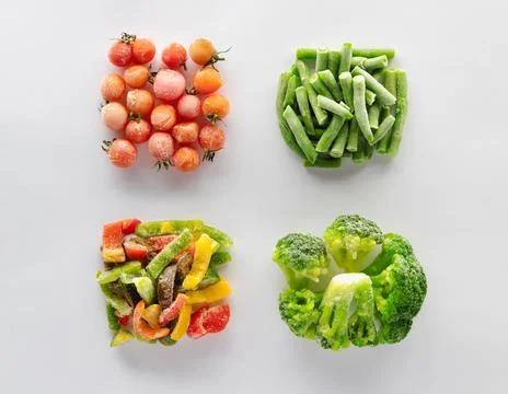Frozen vegetables on a white background. Stock Photos
