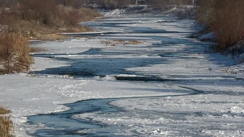 Frozen water surface holds ice sheets and cracks across a winter - Ice Layer Stock Footage 339818082