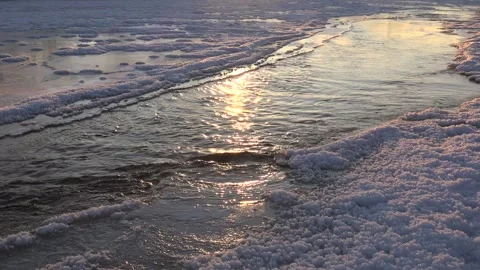 Frozen water surface holds ice sheets and cracks across a winter - Glassy Ice Stock Footage 339818086