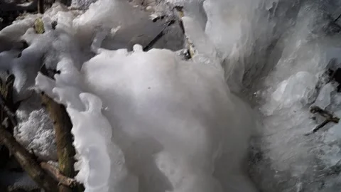 Frozen waterfall. Blocks of ice on a forest waterfall. Frozen forest stream. Stock Footage 171999486