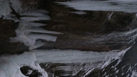 Frozen waterfall close-up. Vertical 4K video. Stock Footage 237216648
