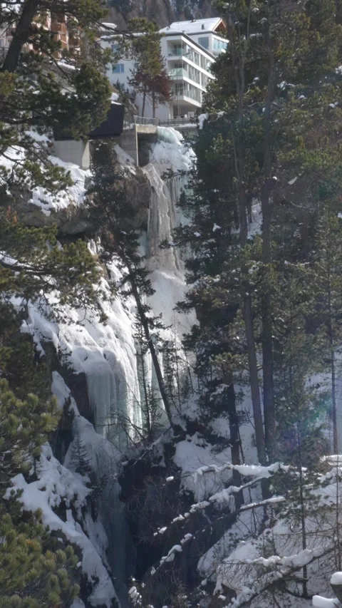 Frozen waterfall flowing through mountainous canyon in pontresina switzerland Stock Footage 329555235