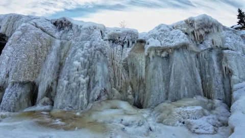 Frozen Waterfall with Flowing Water Behind Ice in Winter Stock Footage 329582700