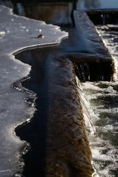A frozen waterfall. Ice on the river Stock Photos