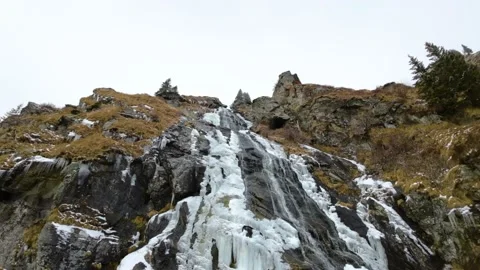Frozen waterfall on the mountain. Low Angle View of ice waterfall Stock Footage 224733824