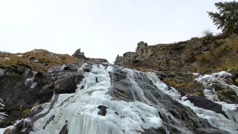 Frozen waterfall on the mountain. Low Angle View of ice waterfall Stock Footage 224733962