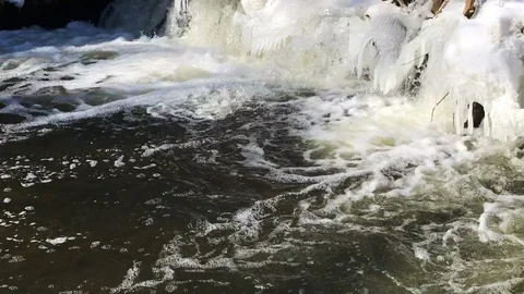 Frozen waterfall in springtime river Stock Footage 86930283