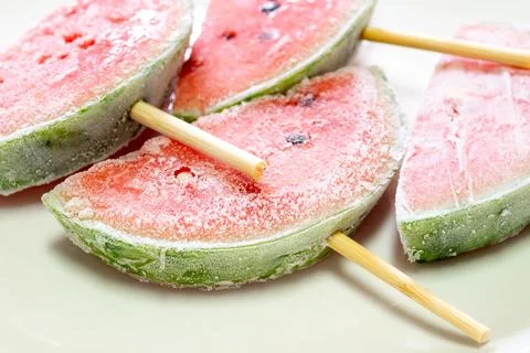 Frozen watermelon popsicles cut in half Stock Photos