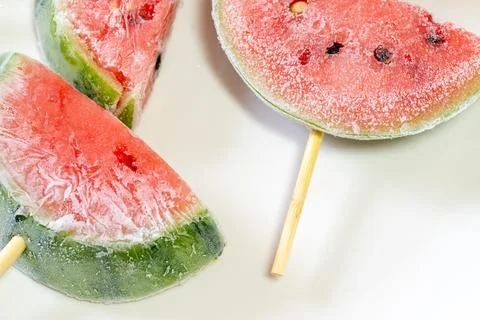 Frozen watermelon popsicles cut in half Stock Photos