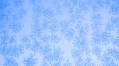 Frozen window patterns. Blue background. Abstraction. Frost Stock Photos