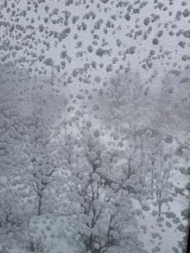 Frozen window with snowflake patterns Stock Photos