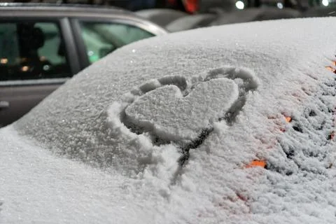 A frozen windshield with a heart. Stock Photos