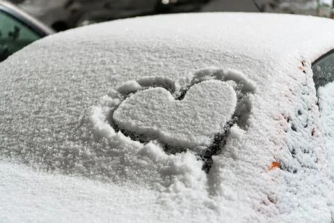 A frozen windshield with a heart. Stock Photos