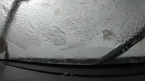 Frozen windshield wipers during car running in snowstorm high altitude mountains Stock Footage 302018544