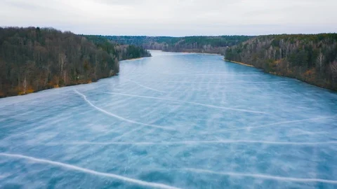 Frozen winter lake covered by ice, aerial view Stock Footage 104300810