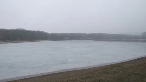 Frozen winter lake during snowfall Video stock 170446701