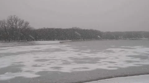 Frozen winter lake during snowfall Stock Footage 170446750