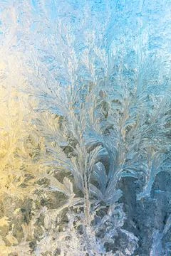 Frozen winter window with shiny ice frost pattern texture. Christmas wonder Stock Photos