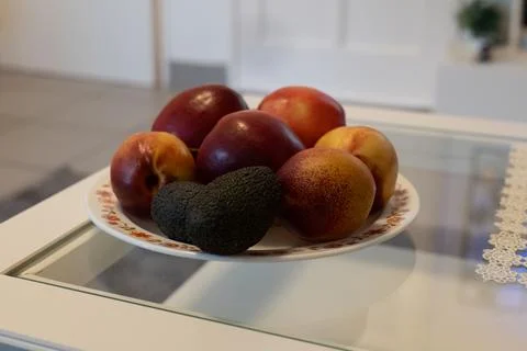 Fruit and avocados on a plate Stock Photos