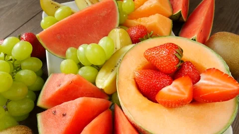 Fruit and berries in a plate. Video stock 302472935
