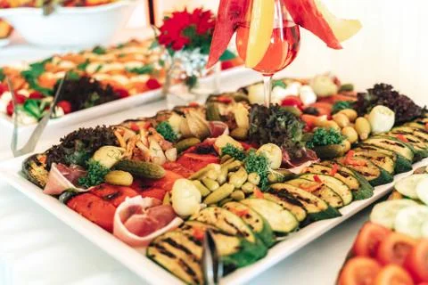Fruit and vegetable buffet table and of glass of red beverage. Celebration Stock Photos
