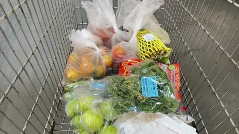 Fruit and vegetable inside a moving trolley shopping cart at Makro, Thailand Video stock 232609018