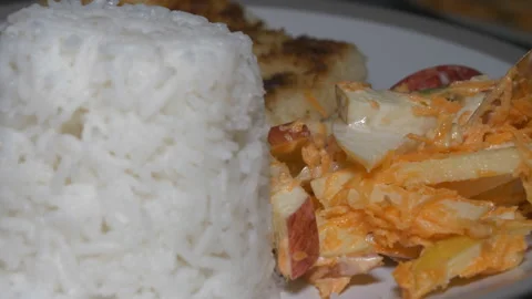 Fruit and vegetables salad, cooked rice and grilled halloumi. Video stock 114983394