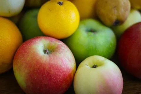 Fruit background. Apples, oranges, pears, persimmons, plums. Stock Photos