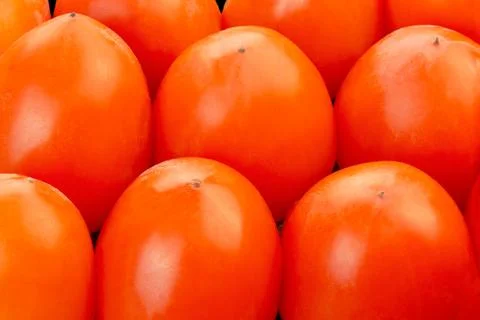 Fruit background of closeup on a box of fresh persimmon. Stock Photos