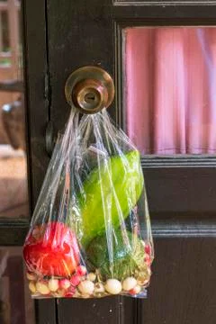 Fruit bags hanging at the door knobs 스톡 사진