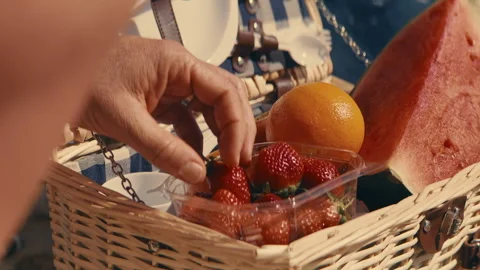 Fruit basket on the beach consisting of strawberries oranges and watermelon Stock Footage 262407198