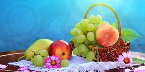 Fruit basket isolated on blue background. Nature background. Stock Photos