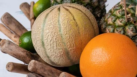 Fruit basket with melon, orange, lime and pineapple. Stock Photos
