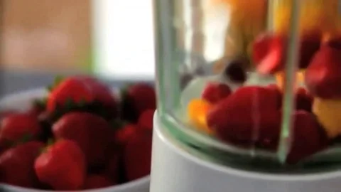 Fruit being added to blender for smoothie Stock Footage 98247580