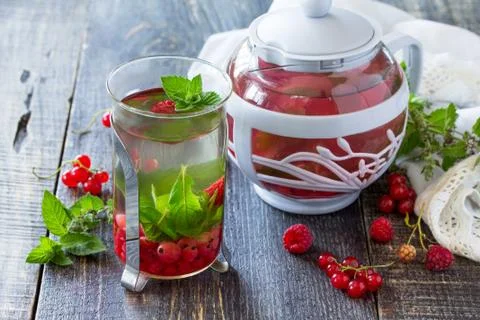 Fruit berry tea with mint, red currant and raspberries. Stock Photos