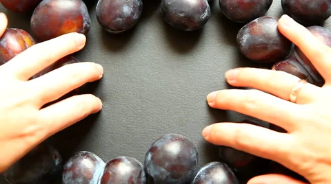 Fruit black background with plums, hands making free copy space 스톡 동영상 65419495
