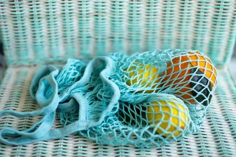 Fruit in blue string bag Stock Photos