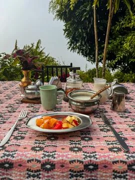 Fruit breakfast with Nepalese utensils on the table in the Himalayan mountain Stock Photos