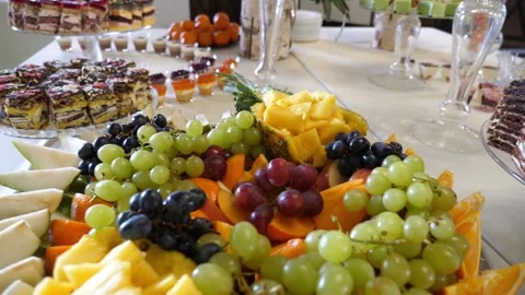 Fruit buffet. Grapes, pineapples, oranges, apples and others. Slow motion. Stock Footage 262475009