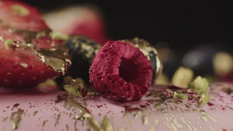 Fruit on the cake close up sprinkled with gold paint. Trendy cake. Video stock 155790568