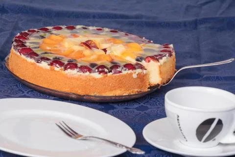 Fruit cake with empty coffee cup and cake plate Stock Photos